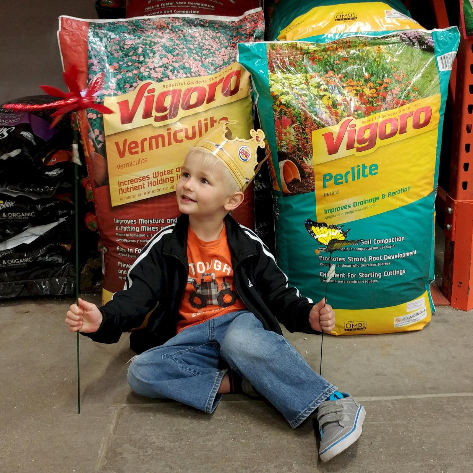 Large 4 cubic foot bags of vermiculite and perlite in a home improvement store garden section, the insulation ingredients for a DIY pizza oven hearth