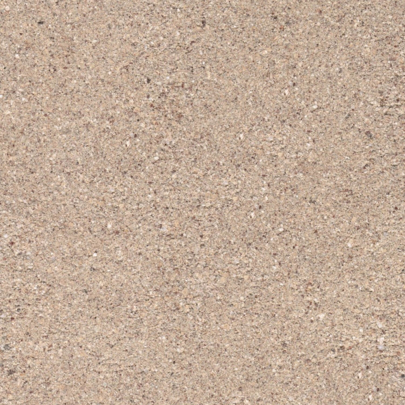 Close-up of the sandy tan surface texture of a dense fire brick