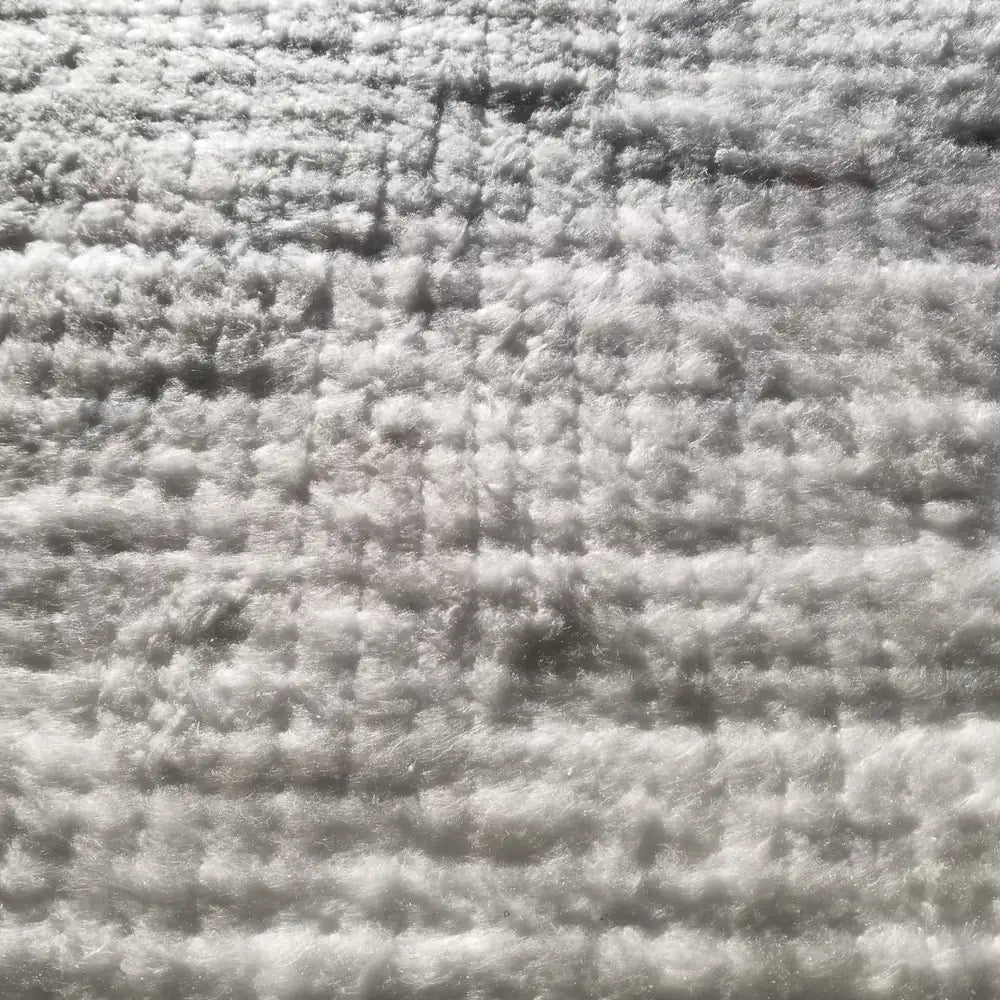 Close-up of ceramic fiber blanket showing the needled, high-temperature insulation fibers
